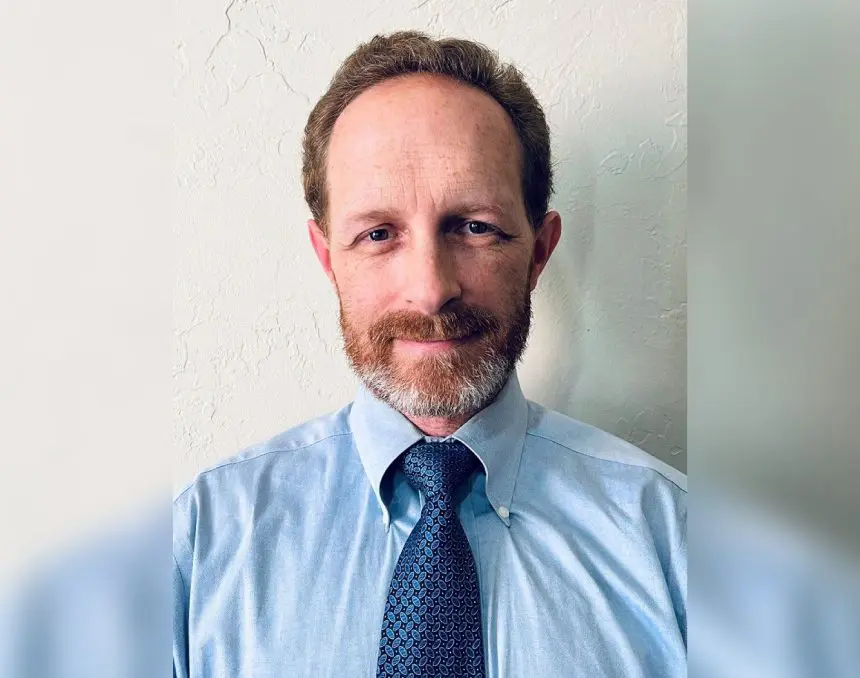 A man in a blue shirt and tie.